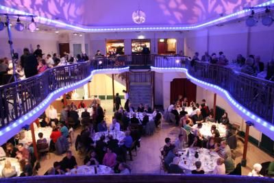 View of ground floor of Winter Garden from balcony with bright lights set up for a wedding